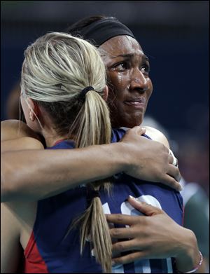 Foluke Akinradewo grimaces as she embraces U.S. teammate Jordan Larson after losing to Brazil.