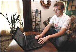 Nick Cousino, a student at Bedford High School, works on a spreadsheet program at his Lambertville home. Nick says he wants to major in accounting at Michigan State University.