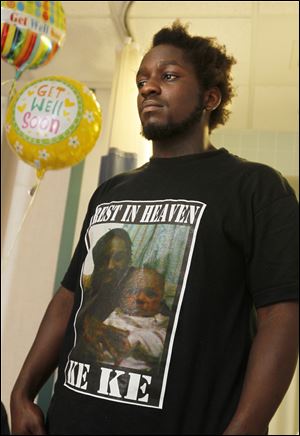 Deandre Hooks stands in the hospital room of his daughter, Leondra Hooks, 2,  at St. Vincent Mercy Medical Center in Toledo.  Leondra was wounded, and her sister, Keondra, 1, was killed, when someone shot into their apartment at Moody Manor last week.