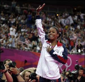 U.S. gymnast Gabrielle Douglas acknowledges the audience after being declared winner of the gold medal during the artistic gymnastics women's individual all-around competition at the 2012 Summer Olympics.