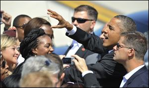 President Barack Obama greets a crowd of people Saturday after arriving at O'Hare International Airport in Chicago.