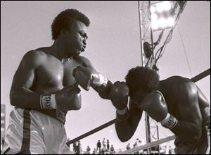 Michael Dokes, left, pounds on Mike Weaver en route to winning the heavyweight title in December, 1982.