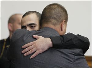 Bandar Abu-Karsh hugs his attorney John McMahon after being found not guilty in the death of Lamar Allen.