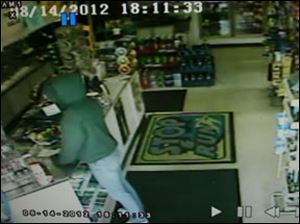 This image from surveillance video shows a female suspect in an armed robbery of the Stop and Run store, 2062 S. Custer Rd., Monroe Township.