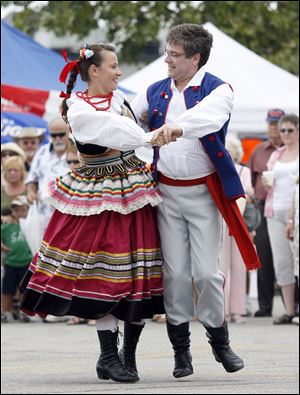 Location: Maria Szkudlarek, left, and Rob Szczublewski, Toledo, dance with other members of the Toledo group Echoes of Poland.