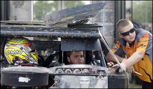 University of Northwestern Ohio students and racing team members Kody Weisner, left, and Harry Smith prepare for an event in Lima. UNOH is one of the first schools in the nation to offer a high-performance motorsports curriculum and major. 