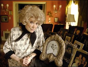 Phyllis Diller poses with her photos at her home in the Brentwood section of Los Angeles in 2005. 