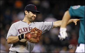 Cleveland Indians first baseman Casey Kotchman throws to first on a sacrifice bunt by Seattle Mariners' Dustin Ackley in the seventh inning of a baseball game Monday.