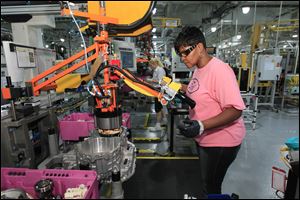 United Auto Workers assemblyman Carlena Butler works the transmission line at Ford's Van Dyke Transmission Plant in Sterling Heights, Mich.