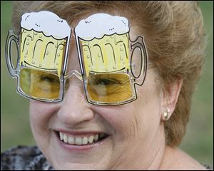 Karen Tiede of Britton, Mich, enjoys a pair of 'beer mugs' at the 2011 festival.