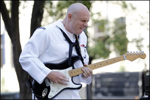 Musician Third Class Pat Waters plays a guitar solo with the Navy Band during a lunch time performance Wednesday at Levis Square as part of Navy Week.