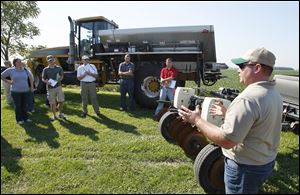 Todd Hecht of Helena Chemical Co. in Martin, Ohio, explains how a soil sampling system works at the Whipple farm in Oak Harbor.