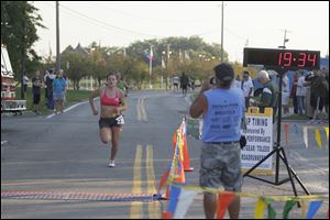 U.S. Army Specialist Patti Swayka, of Wisconsin, is the first woman to cross the finish line in the 