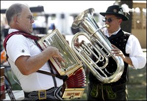 Rob Schwalbe, left, and Erwin Rauschendorfer, both of Detroit, play during the annual German-American Festival. The festivities run from noon to 11 p.m. today.