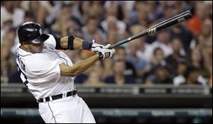Detroit Tigers' Jhonny Peralta hits a double in the eighth inning to drive in Prince Fielder and Andy Dirks against the Los Angeles Angels in a baseball game Saturday.