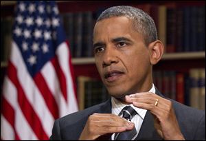 President Barack Obama speaks during an interview.