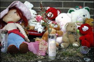 A memorial is still on the stoop of the apartment in Moody Manor where Keondra, 1, and Leondra Hooks, 2, were shot as they slept in their great-grandmother's house. Keondra did not survive.