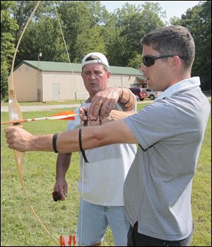 Instructor Mike Matthews, of Toledo, left, and RCN Lt. Vincent Martel. Martel is on the HMCS Ville de Quebec, based in Halifax, Nova Scotia.   About two dozen sailors from the Royal Canadian Navy were hosted by the Tomahawk Archers at their 43 acre site in Temperance, Michigan.