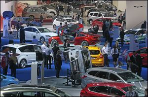 Visitors look at Ford cars on display at the Moscow International Automobile Salon Thursday.