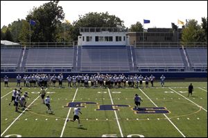 St. John's Jesuit players practice Thursday afternoon as they get acclimated to their new Lyden Field. The Titans will christen the stadium when they meet St. Mary of Orchard Lake, Mich., at 7 p.m. today.