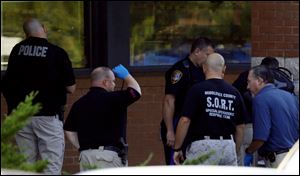 Officials investigate the scene of a shooting today at a  Pathmark grocery store in Old Bridge, N.J.. 