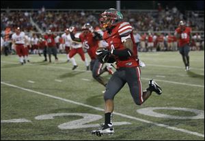 Central Catholic defensive back Jayme Thompson runs back an interception 32 yards for a touchdown in the third quarter against Bedford to put the Irish up 35-14 mere minutes into the quarter.