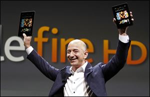 Jeff Bezos, CEO and founder of Amazon, holds the new at the introduction of the new Amazon Kindle Fire HD today in Santa Monica, Calif.
