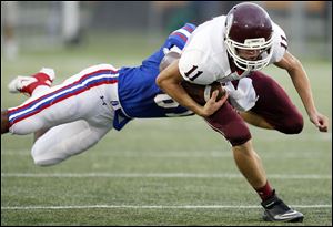 Springfield's Devon Gant (87) tackles Rossord ball carrier Ryan Clay (11) during the first quarter.