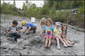 Youngsters play at Fossil Park --  from left, John Humason, 6, Luke Jennewine, 3, Karlee Mitchell, 4, Maria Humason, 3, Jackie Jennewine, 2, and McKenna Heinl, 3. The other park is Centennial Quarry. 