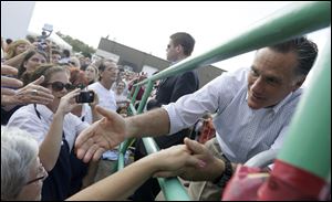 Mitt Romney greets an overflow crowd outside PR Machine Works near Mansfield, Ohio. After his speech Monday, he gave impromptu remarks to the crowd outside. 