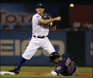 Texas Rangers second baseman Ian Kinsler, top, makes the throw to first for the double play after forcing Cleveland Indians' Jason Kipnis (22) at second in the fourth inning of a baseball game Tuesday.