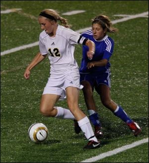 Perrysburg’s Maddy Williams gets in front of Anthony Wayne’s Abby Allen in last night’s Northern Lakes League soccer game. Williams scored three goals as the Yellow Jackets, ranked No. 1 in Ohio, won 4-0 over the No. 10-ranked Generals.