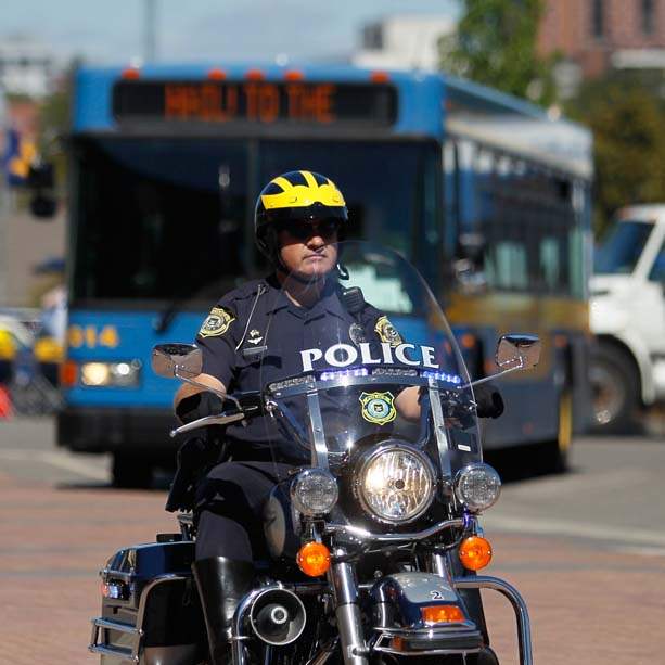 A-police-officer-escorts-the-University-of-Michigan