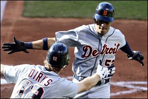 Detroit Tigers' Quintin Berry, right, is congratulated by Andy Dirks after Berry scored on a sacrifice fly by Austin Jackson in the fourth inning of a baseball game, Saturday.