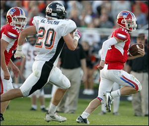 Patrick Henry quarterback Gabe Jones runs the ball against Liberty Center as Kaleb Pohlman give chase on Friday in Hamler.