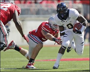 Ohio State's John Simon, left, attempts to bring down California's C.J. Anderson on a day where he played with an ailing shoulder.