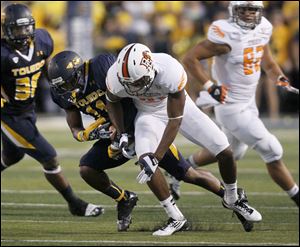 Toledo's Cheatham Norrils, left, intercepts a pass intended for Bowling Green's Chris Gallon during the second quarter on Saturday. Toledo jumped out to a 17-point lead early and won 27-15.