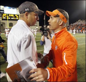 University of Toledo coach Matt Campbell, left, and Bowling Green coach Dave Clawson meet after the Rockets beat the Falcons 27-15 in the Battle of I-75 on Saturday at the Glass Bowl in Toledo.