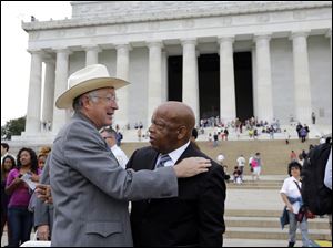 Secretary of the Interior Ken Salazar, left, greets Rep. John Lewis, D-Ga., after at an event sponsored by the National Endowment for the Humanities and Howard University to commemorate the 150th anniversary of Abraham Lincolns preliminary Emancipation Proclamation, Monday, Sept. 17, on the steps of the Lincoln Memorial in Washington.