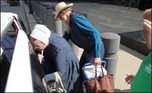 An amish woman and man climb into a van after a verdict in the beard cutting trial Thursday, Sept. 20, at Federal Court in Cleveland. All 16 defendants were found guilty.