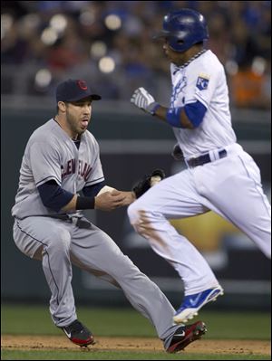 Cleveland Indians second baseman Jason Kipnis fields a ground ball as Kansas City Royals' Alcides Escobar runs by during the fifth inning Friday at Kauffman Stadium in Kansas City, Mo. Kipnis threw out the Royals' Mike Moustakas on the play. Escobar was safe at second.