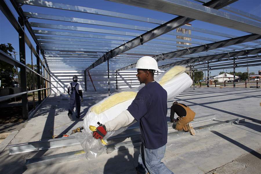 Marco-Harris-carries-a-roll-of-insulation