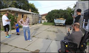 People photograph a driveway in Roseville, Mich. that a tipster said could be the final resting place of missing Teamsters leader Jimmy Hoffa. 