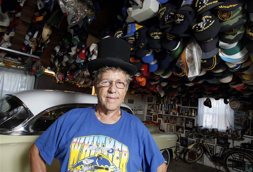 Lee-McBride-with-his-collection-of-4-500-hats