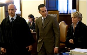 The pope's butler Paolo Gabriele, center, flanked at right by his lawyer Cristiana Arru, leaves the Vatican tribunal, after the verdict, at the Vatican on Saturday.