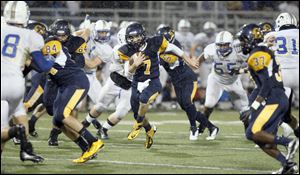 Whitmer quarterback Nick Holley cuts back for a touchdown in the first quarter Friday at Whitmer High School