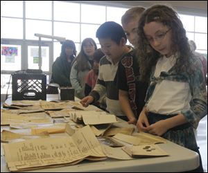 Sasha Meade, of Ridge Elementary School, look at items from the time capsule.