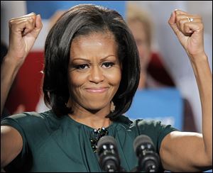 First lady Michelle Obama reacts to the cheers as she campaigns for her husband, President Barack Obama.