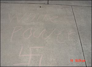 Photo of graffiti that was scrawled on the sidewalk in front of the home of Bowling Green State University basketball coach Louis Orr.