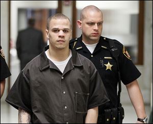 Cameo Pettaway is escorted from Lucas County Common Pleas Court.
